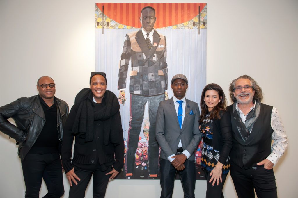 (Left to right) Ron Saleh, Edward Wilkerson, and Phillip Thomas with gallery director Eve Gianni Corio and owner Richard J. Demato in front of Thomas’ painting “Exit”