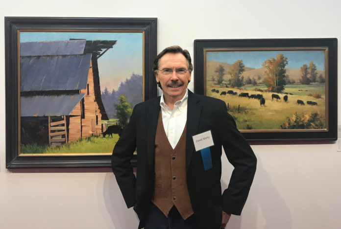 David Marty with his paintings at the Coors Western Show in Denver, Colorado