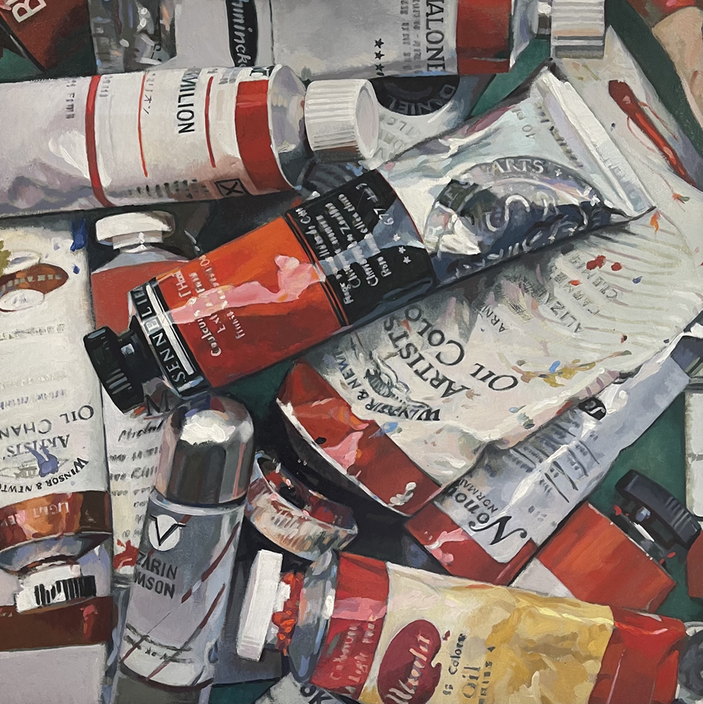 Oil painting of tubes of red oil paints