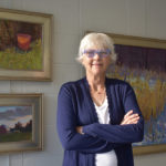 Artist Spotlight: Carol Strock Wasson Woman artist in front of her paintings