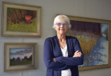 Artist Spotlight: Carol Strock Wasson Woman artist in front of her paintings