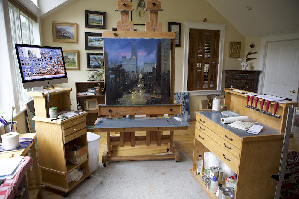 Art studio with paintings on the walls and on an easel
