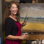 Artist Spotlight: Christine Graefe Drewyer Female artist in her studio in front of one of her paintings on an easel