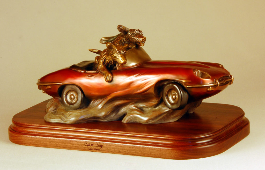 Bronze sculpture with dogs racing in a car