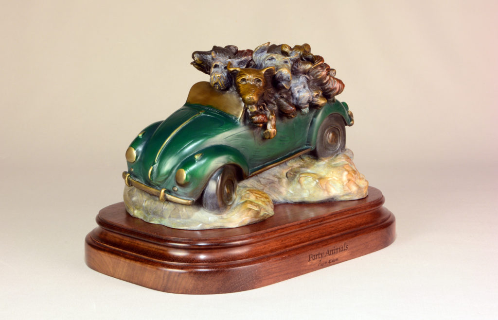 Bronze sculpture of dogs piled into a green VW Bug