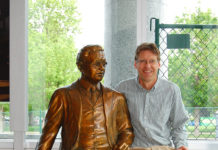 Artist Spotlight: Gary Alsum Male sculptor sitting next to a life size sculpture of a man in a suit