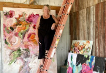 Artist Spotlight: Beth Clary Schwier Female artist on ladder in front of her paintings