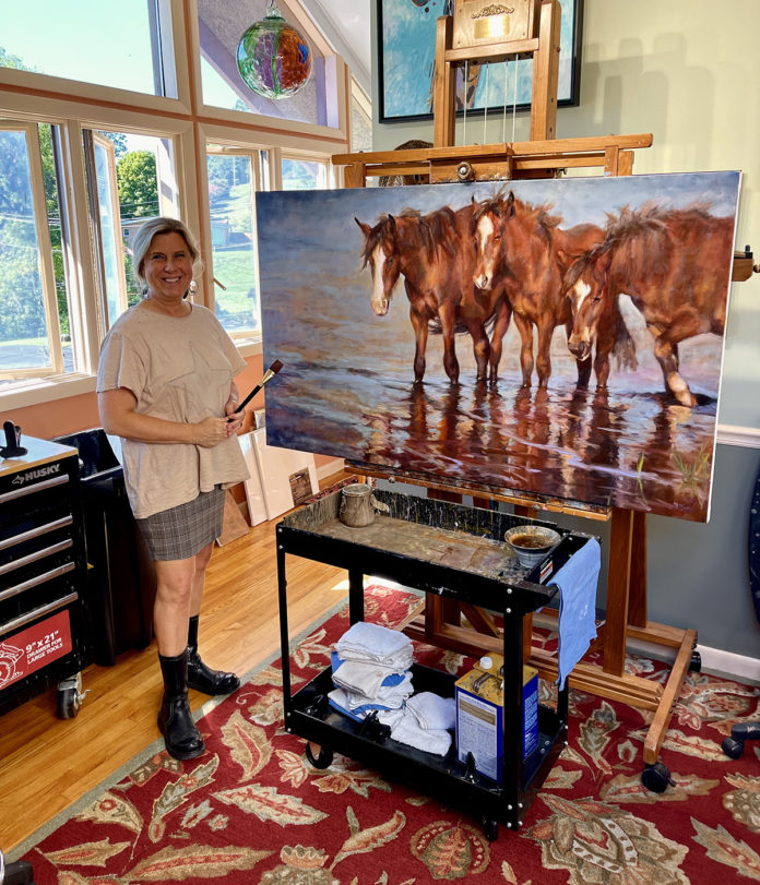 Jenny Buckner in studio with painting