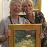 Artist Spotlight: Jill Stefani Wagner PSA-MC IAPS/MC artist holding painting, posing with fellow artist/friend together