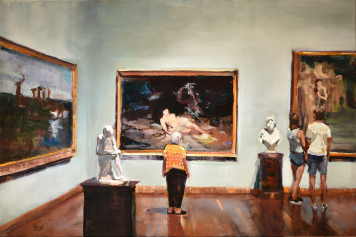 People in a museum, looking around the artwork