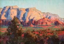 Featured Artwork: Susiehyer oil painting of desert landscape; sun hitting mountains; foliage in the foreground