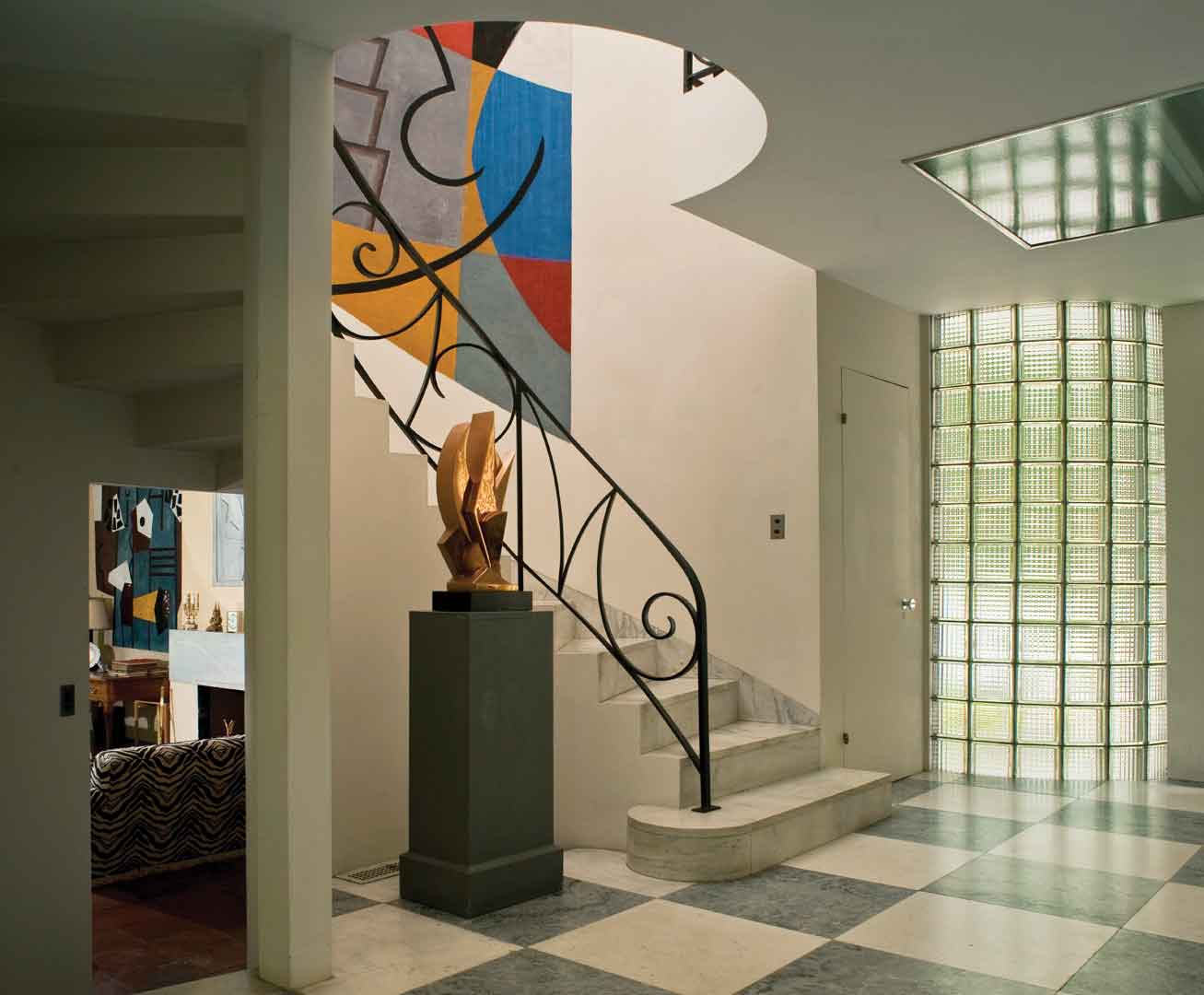 Foyer, with a glimpse into the living room, at the home of abstract painters Suzy Frelinghuysen and George L.K. Morris, featuring works by Morris (foyer fresco and sculpture; living room frescos and bas-relief); photo: Geoffrey Gross, courtesy Frelinghuysen Morris House & Studio, Lenox, Massachusetts