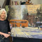 Artist Spotlight: Brenda Boylan artist posing with her painting