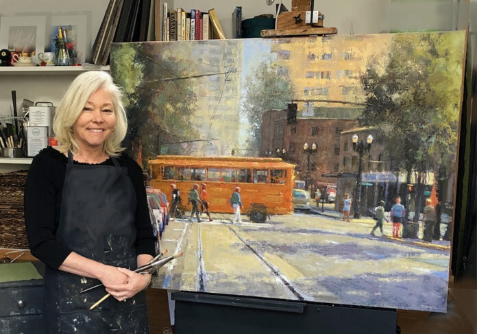 artist posing with her painting