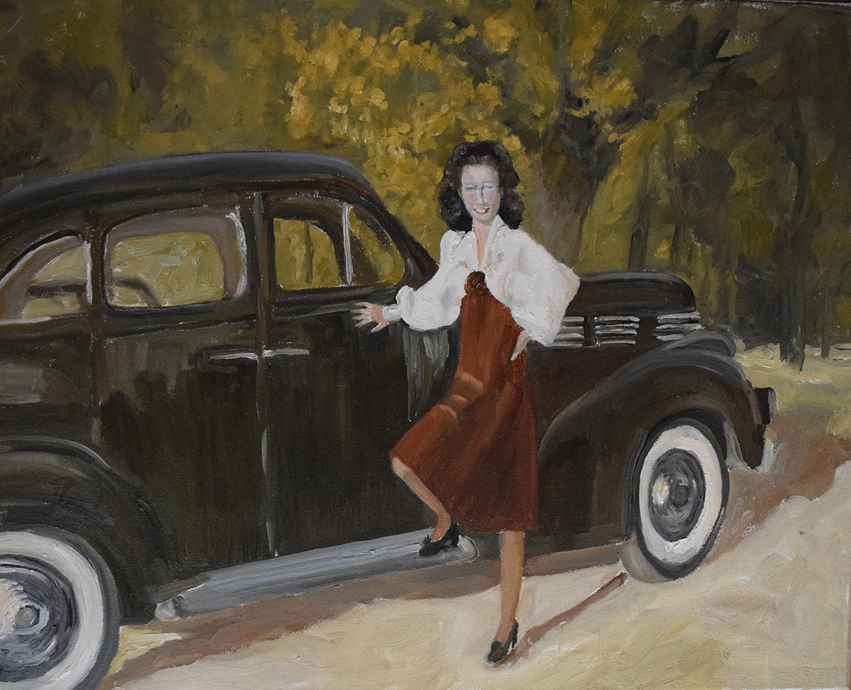 A woman standing next to a black 1950's car