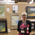 Artist Spotlight: Carol Wasson photo of myself with artwork; Judge for the Bluff Strokes plein air competition 2023 in Dubuque, Iowa