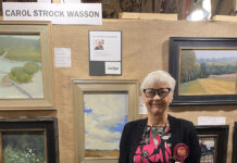 Artist Spotlight: Carol Wasson photo of myself with artwork; Judge for the Bluff Strokes plein air competition 2023 in Dubuque, Iowa
