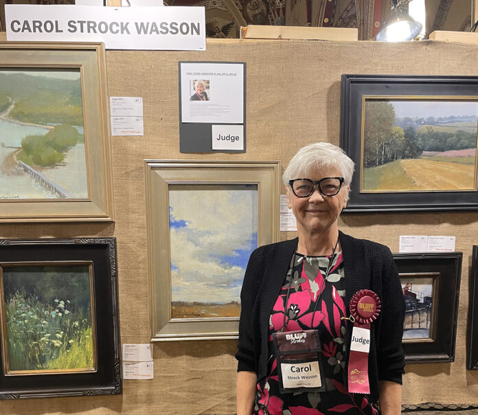photo of myself with artwork; Judge for the Bluff Strokes plein air competition 2023 in Dubuque, Iowa