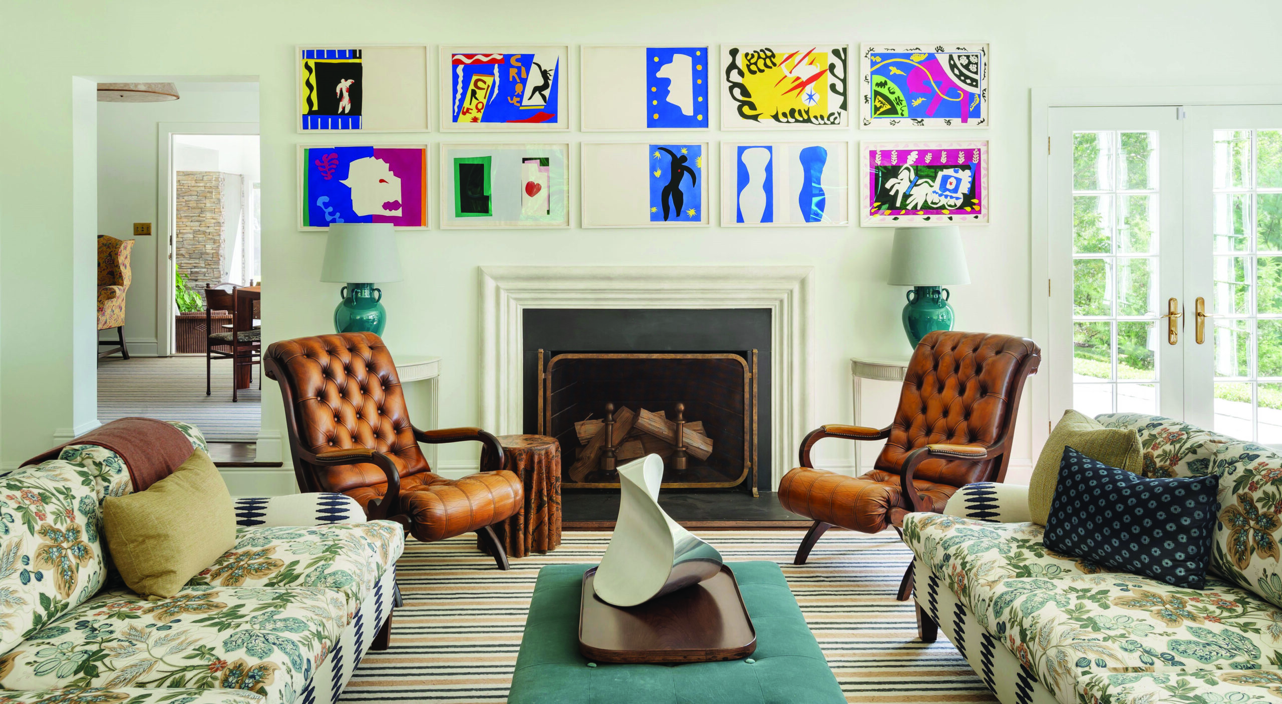 Huniford Design Studio complemented the bold coloring and patterns of Matisse's Jazz prints with the chairs’ rich brown leather upholstery and an unusual mix of striped and floral-printed fabrics. Photo: Matthew Williams 