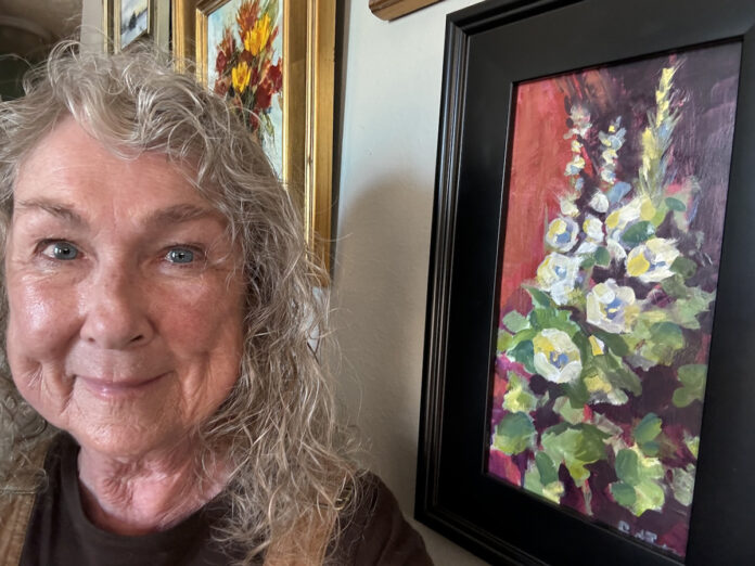artist with painting of Hollyhock