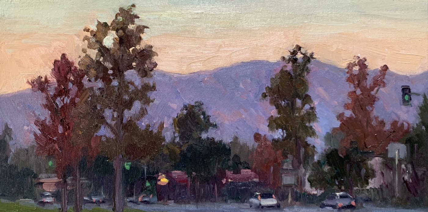 oil painting of mountain range in distance with trees in foreground with sunset 