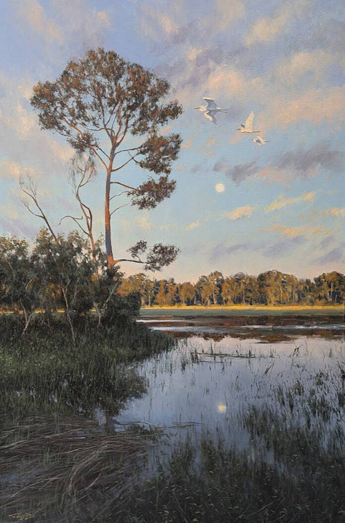 oil painting of marshland with tall tree in foreground, surrounded by mountains and trees during sunset