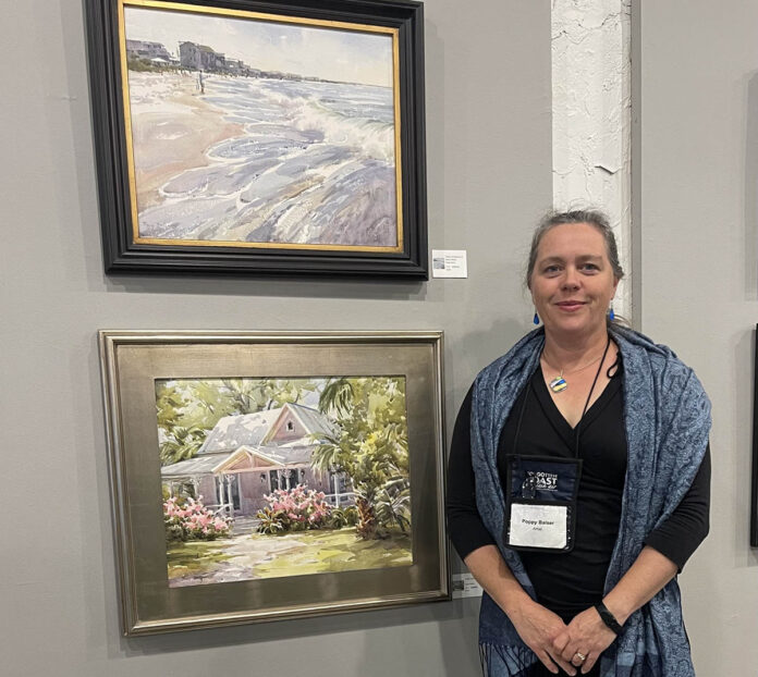 photo of artist with her paintings