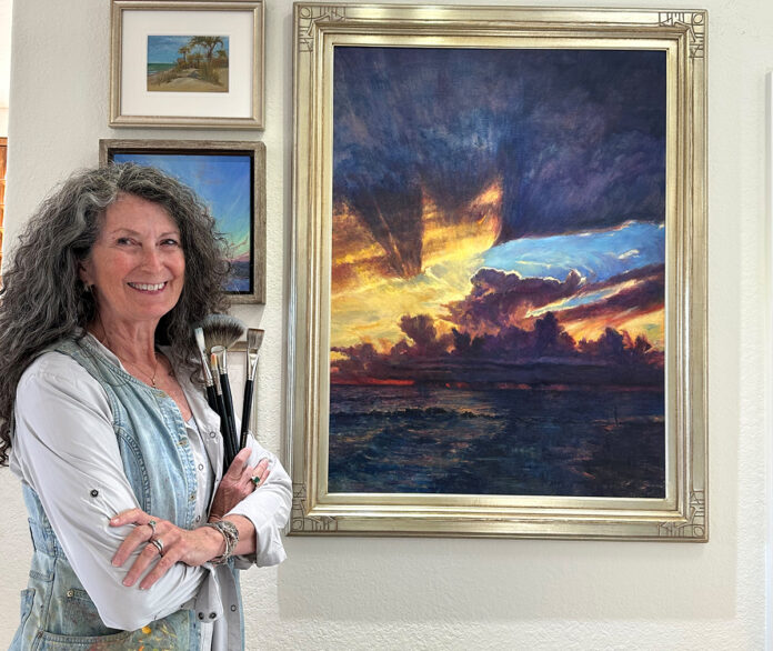 Karen Ann Hitt with Majesty By Still Waters painted for a benefit exhibit to honor Caspersen Beach which was decimated by back to back hurricanes. All roads remain closed to the area. Available at Collectors Gallery and Framery in Venice FL to help benefit a hard hit area. 40x30 oil on linen, 2025 Karen with her painting hanging in gallery