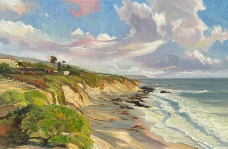 A colorful painting of a coastal landscape with cliffs, green vegetation, and waves crashing onto a sandy beach under a sky with clouds and patches of blue. 15th Annual PleinAir Salon Art Competition