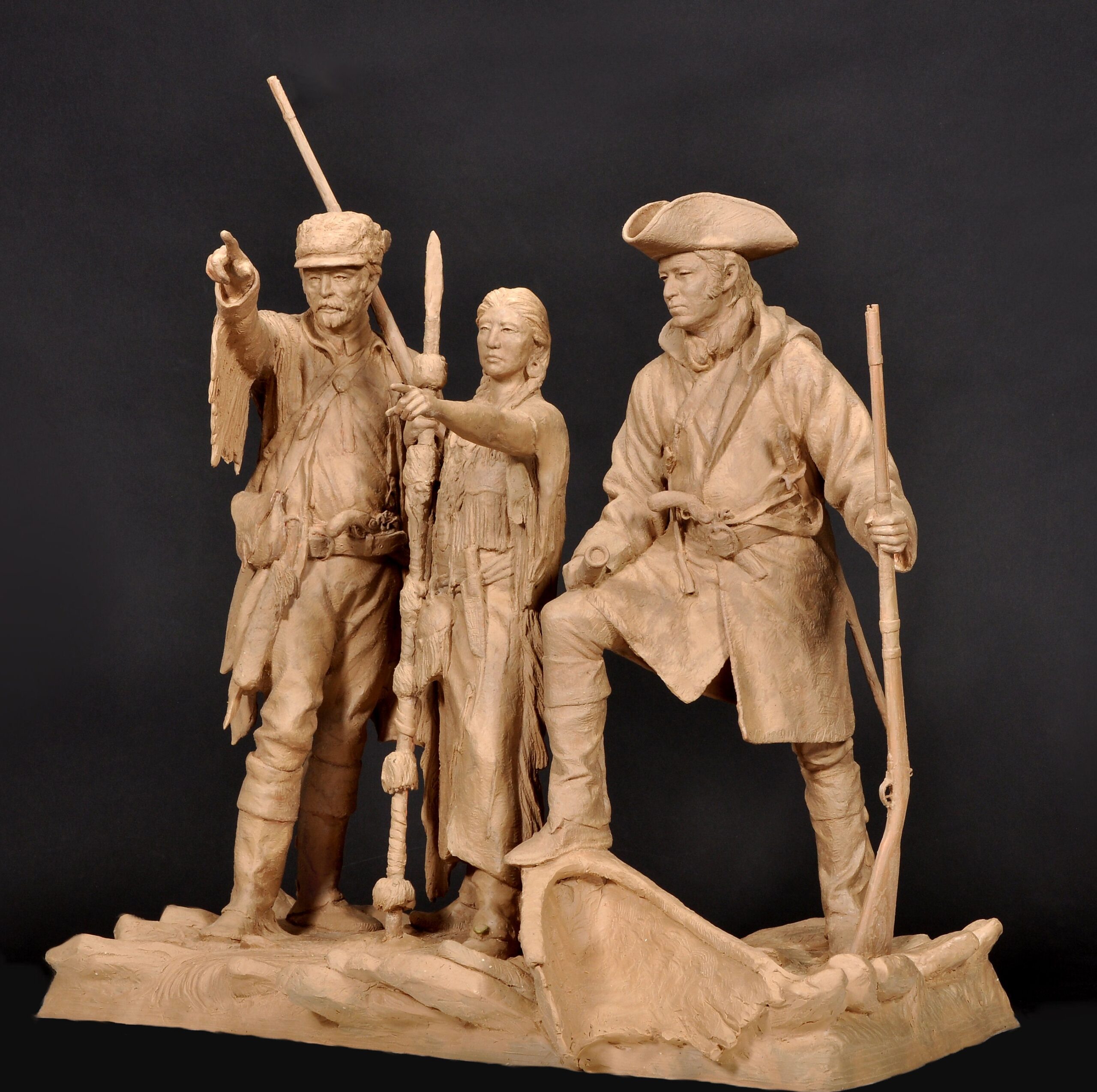 figurative representation of Lewis & Clark with Sacagewea, pointing toward an unseen point on the horizon. 